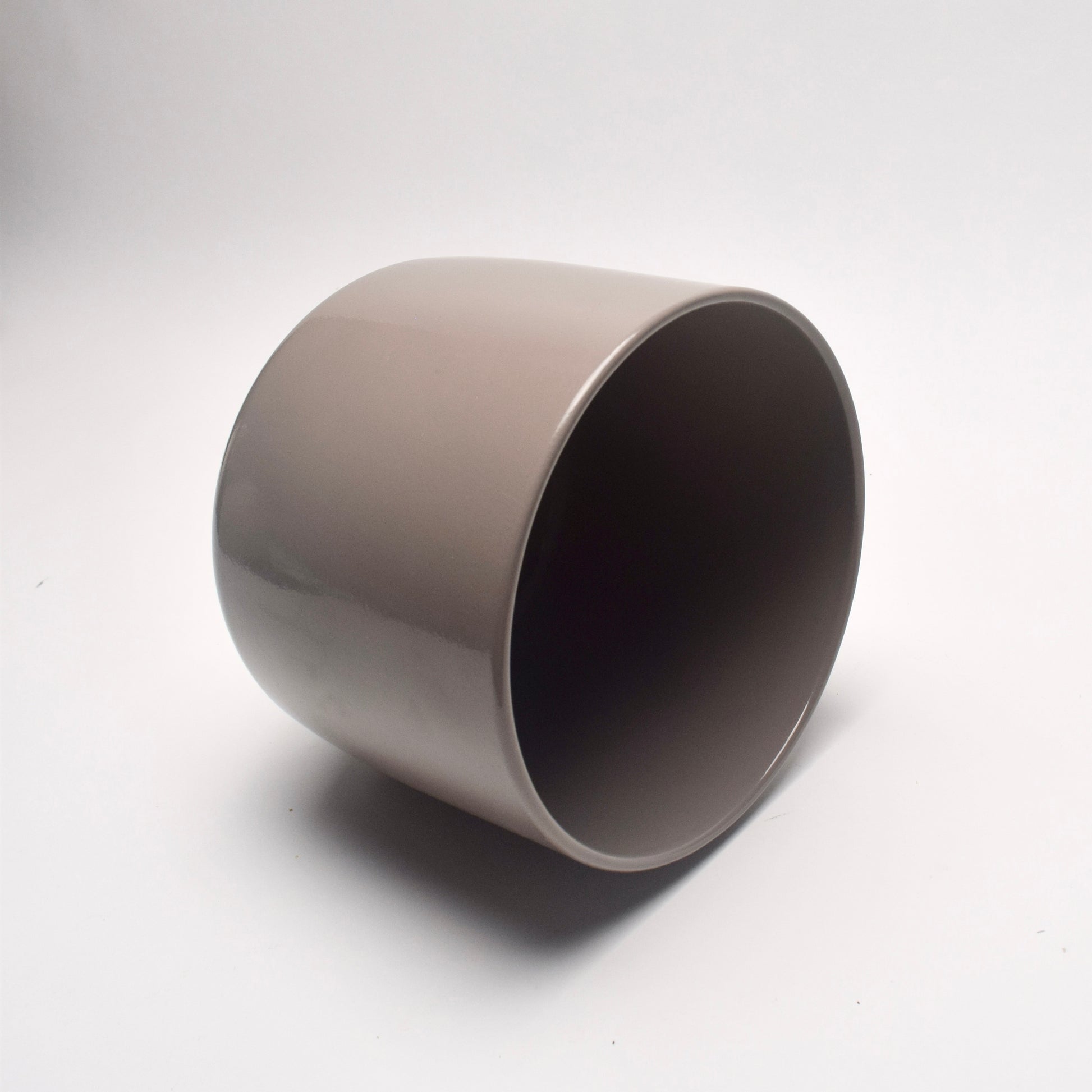 Round taupe glazed ceramic plant pot with a smooth texture