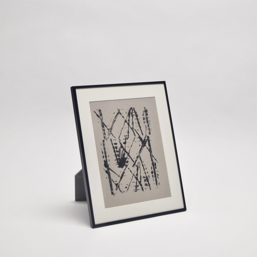 Framed abstract artwork on taupe paper with black paint and a mount for a professional look