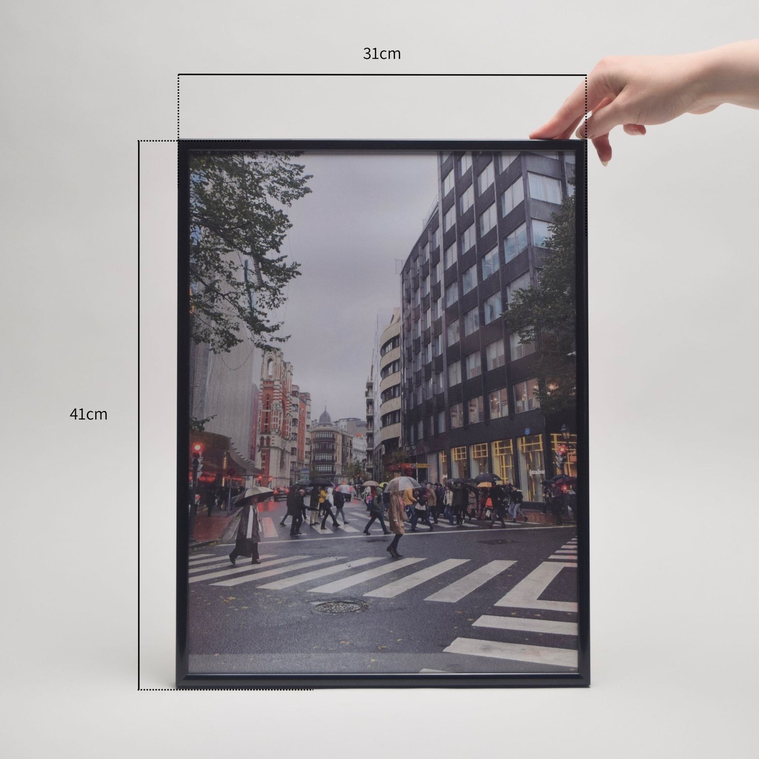 Framed cityscape print with dimensions indicated