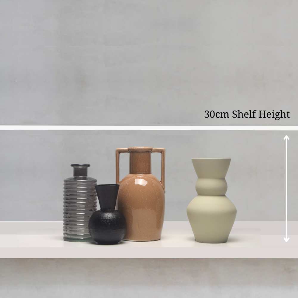 Four vases of different shapes and colours on a shelf with a measurement label indicating 30cm shelf height.